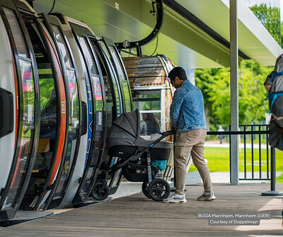Guest loading a stroller onto a Doppelmayr gondola cabin